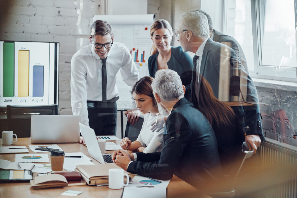 Successful business team analyzing sales while having staff meet